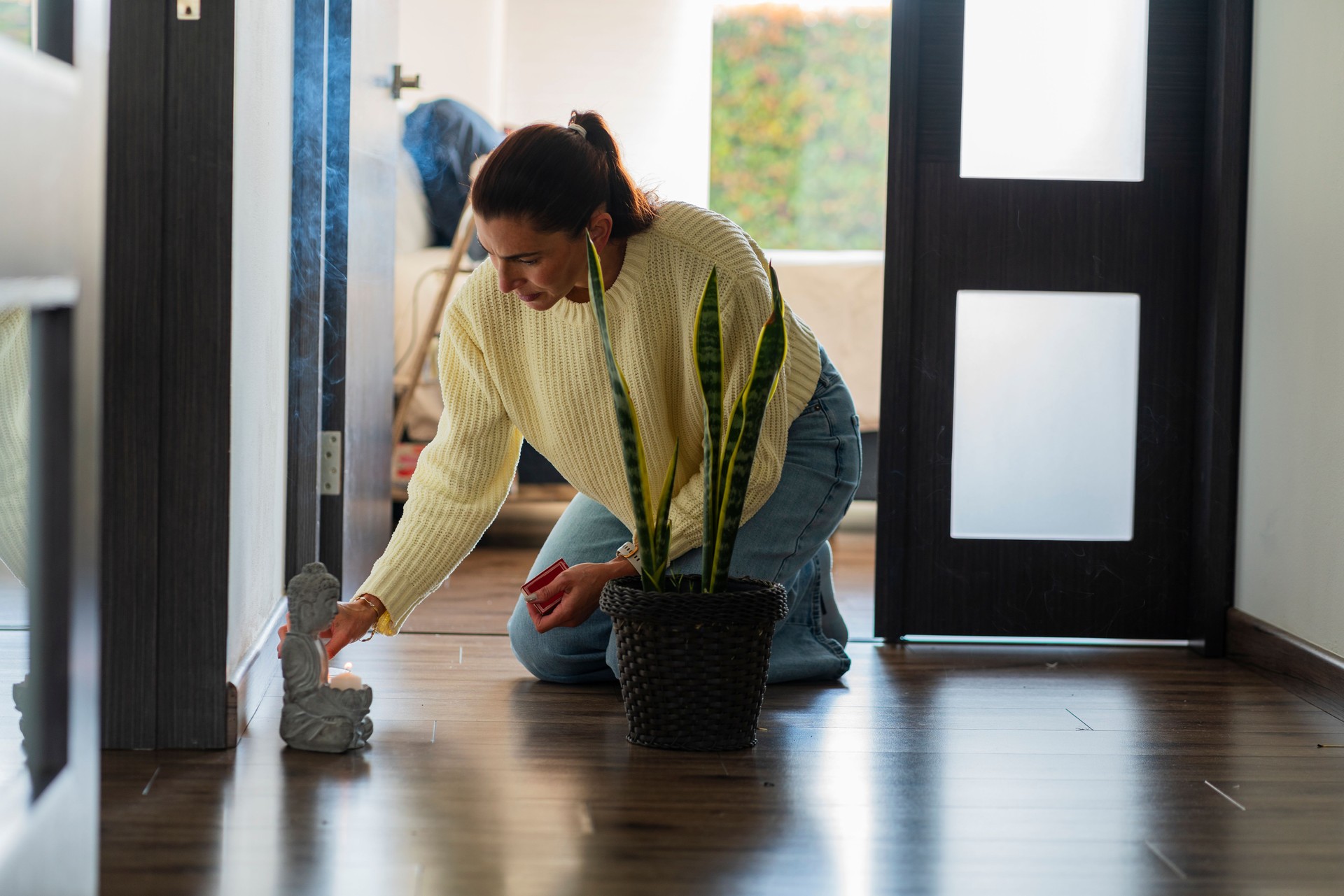 Relaxation of a woman alone at home doing meditation sitting on the floor while doing her breathing exercises