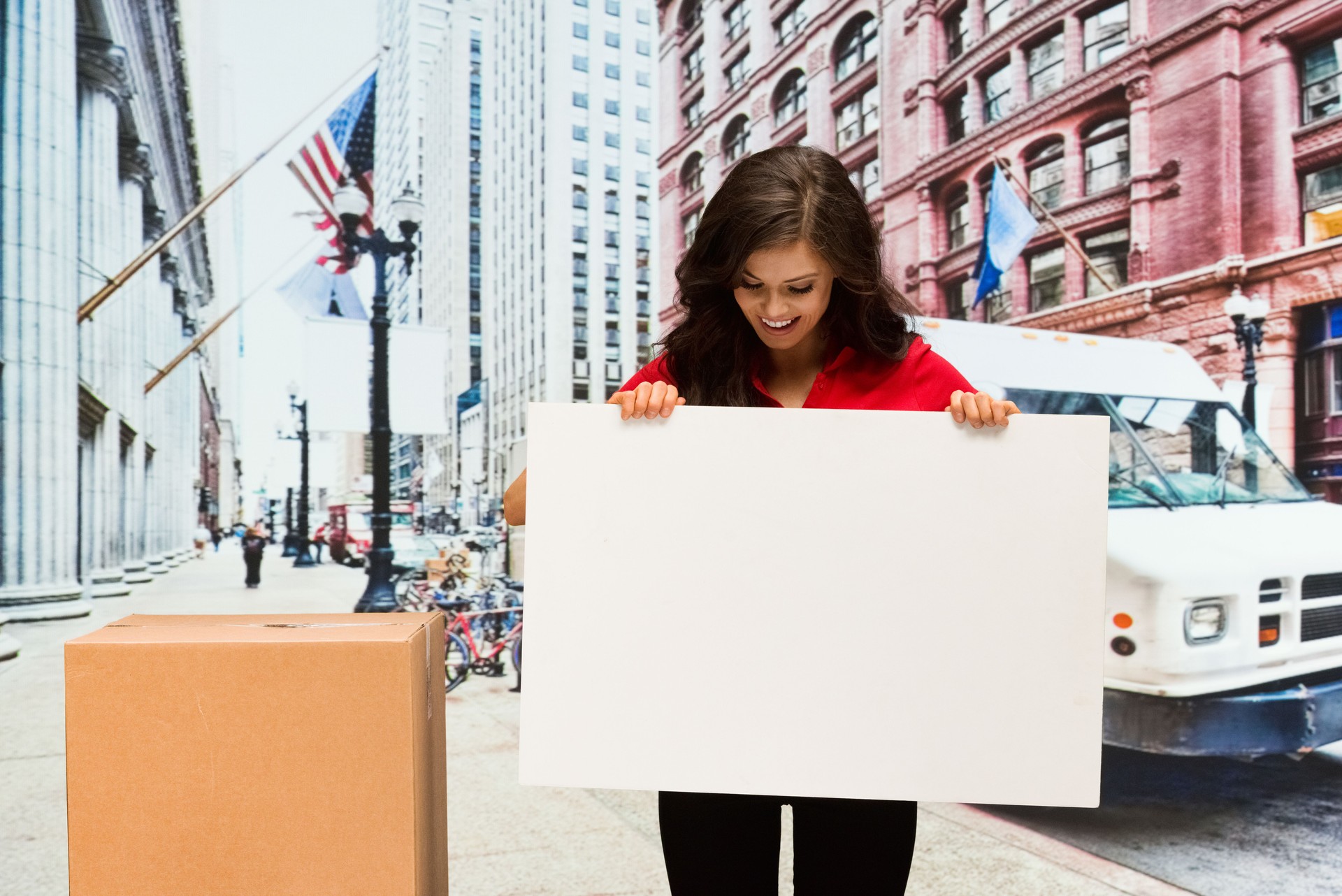 Smiling female worker holding placard outdoors